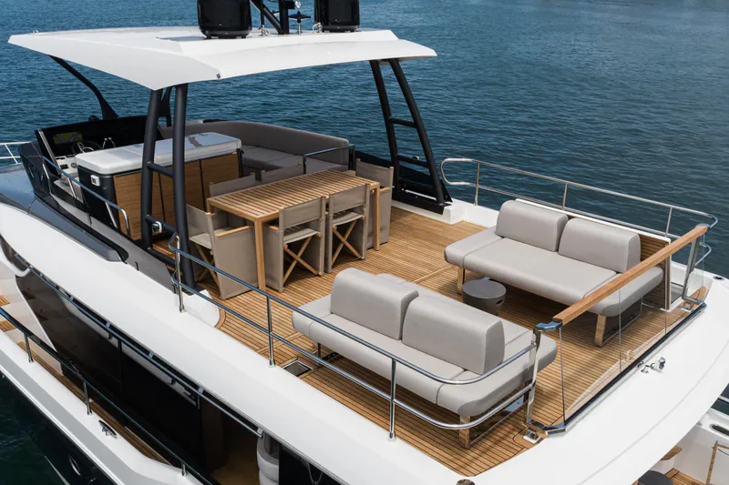  Yacht Photos Pics Luxurious 2024 Prestige X60 yacht deck with elegant seating and dining area.