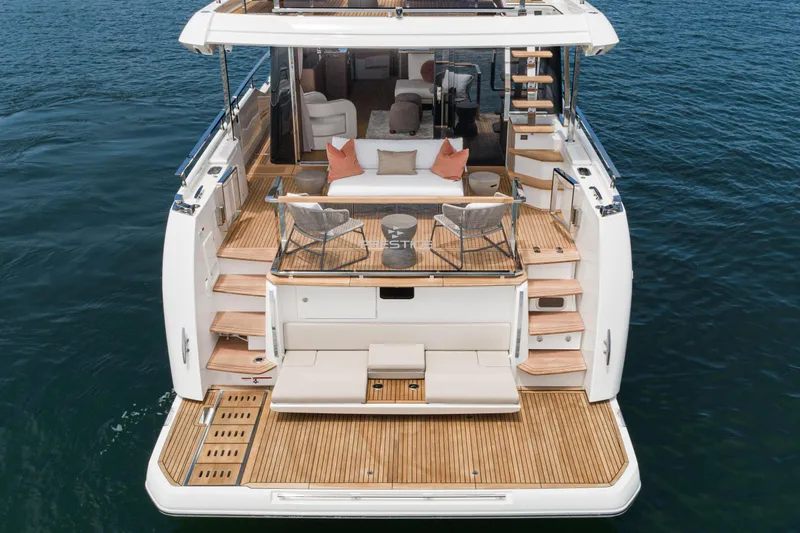  Yacht Photos Pics Luxury 2024 Prestige X60 yacht with elegant deck and seating area on the water.