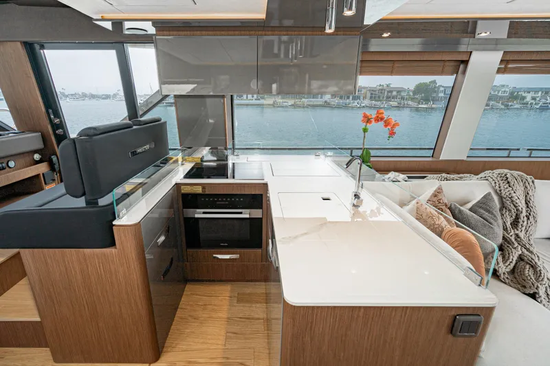  Yacht Photos Pics Luxurious 2024 Prestige X60 yacht interior with modern kitchen and waterfront view.