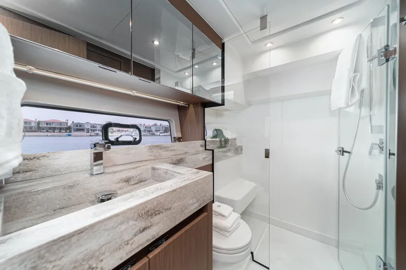  Yacht Photos Pics Luxurious 2024 Prestige X60 yacht bathroom with modern fixtures and elegant design.