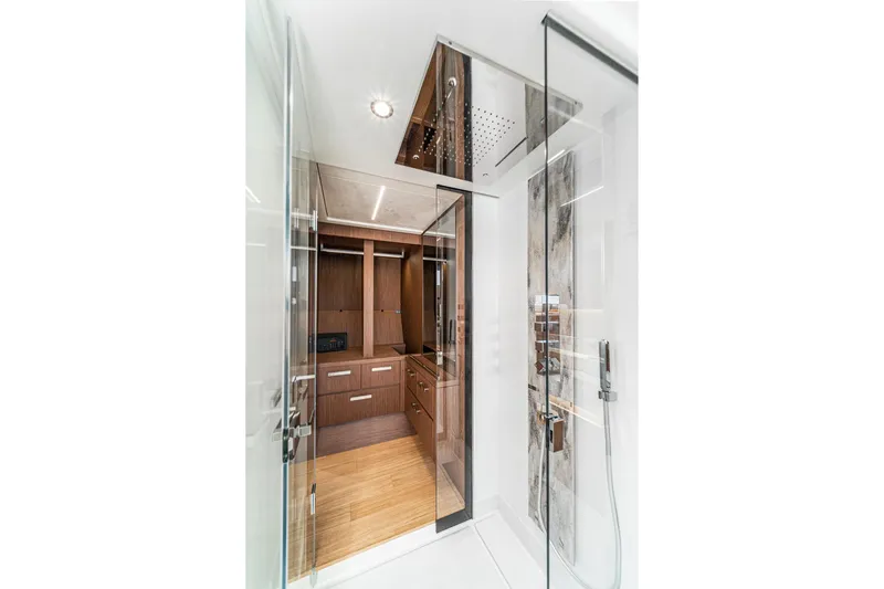  Yacht Photos Pics Luxurious interior of 2024 Prestige X60 yacht featuring modern shower and wooden cabinetry.