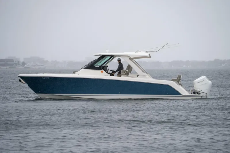 Yacht Photos Pics 2024 Tiara Sport 34 LS boat cruising on a calm, overcast day.