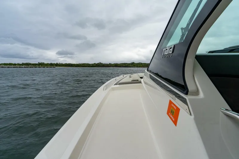  Yacht Photos Pics 2024 Tiara Sport 34 LS boat cruising on a cloudy day.