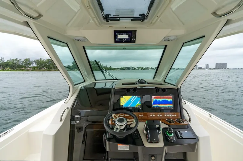  Yacht Photos Pics 2024 Tiara Sport 34 LS boat cockpit with advanced navigation displays on open water.