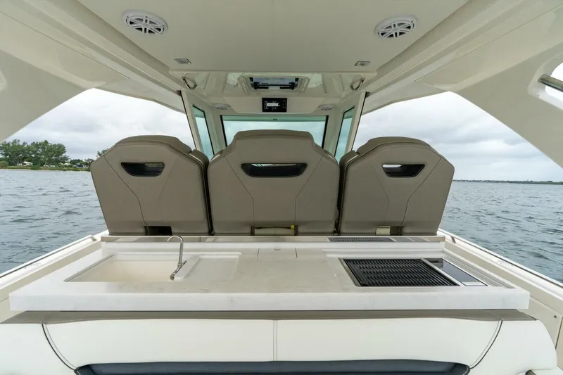  Yacht Photos Pics 2024 Tiara Sport 34 LS boat interior with seating and outdoor kitchen setup.