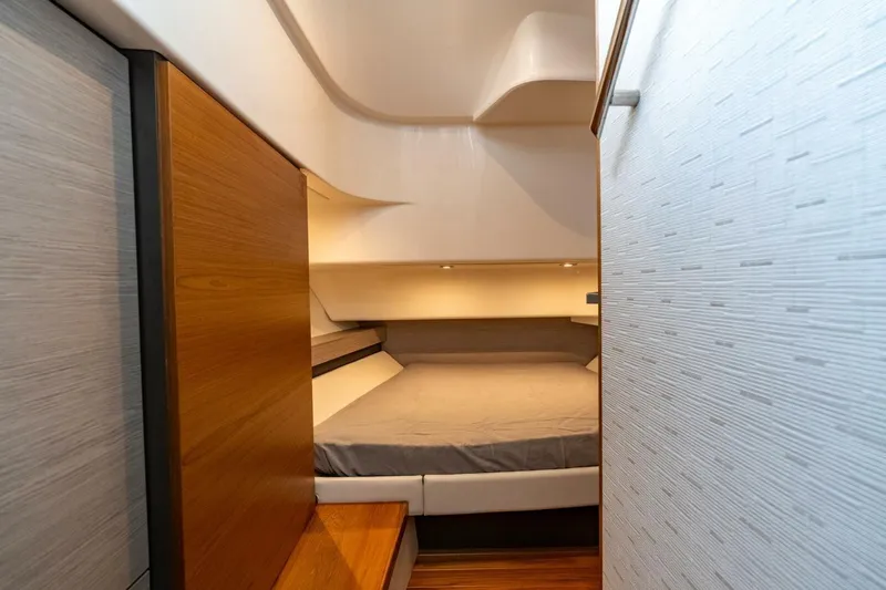  Yacht Photos Pics 2024 Tiara Sport 34 LS cabin interior with modern design and cozy sleeping area.