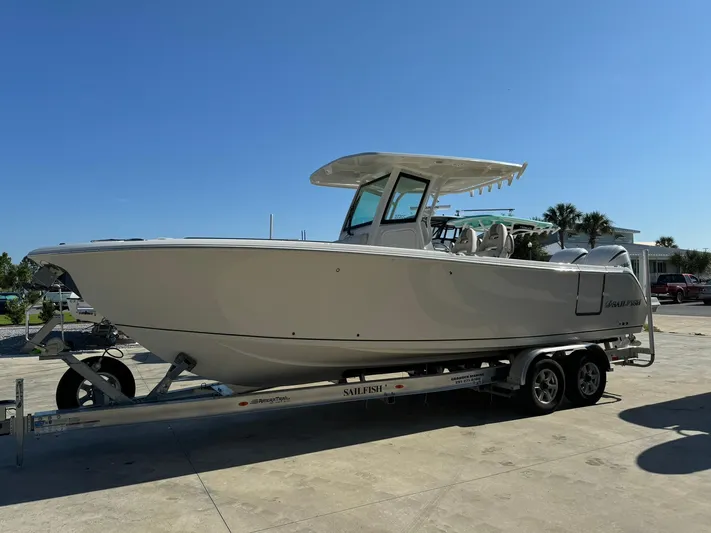  Yacht Photos Pics 2025 Sailfish 272 CC boat on trailer under clear blue sky.