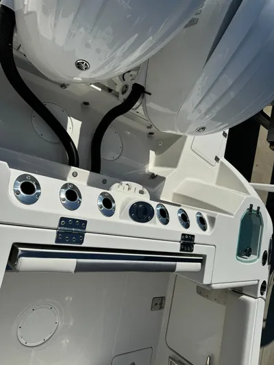  Yacht Photos Pics 2025 Sailfish 272 CC boat dashboard with controls and storage compartments.