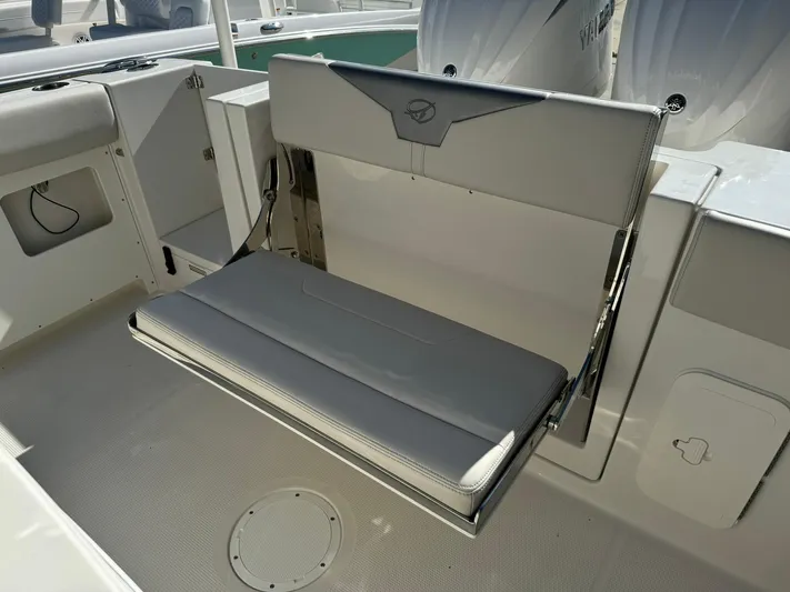  Yacht Photos Pics 2025 Sailfish 272 CC boat interior with foldable seating and storage compartments.