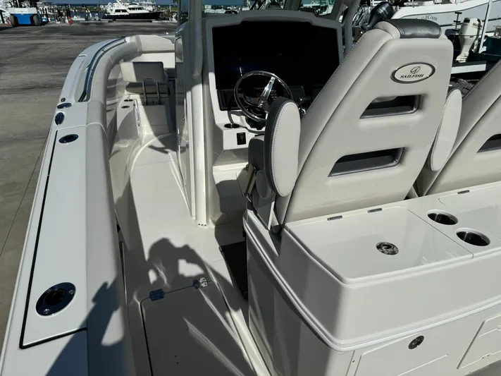  Yacht Photos Pics 2025 Sailfish 272 CC boat interior with helm and seating area.