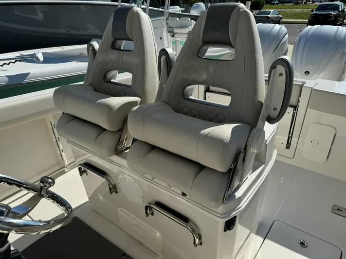  Yacht Photos Pics 2025 Sailfish 272 CC boat with dual cushioned seats and steering wheel.
