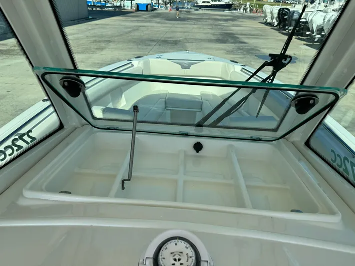 Yacht Photos Pics 2025 Sailfish 272 CC boat interior with open windshield and storage compartment.