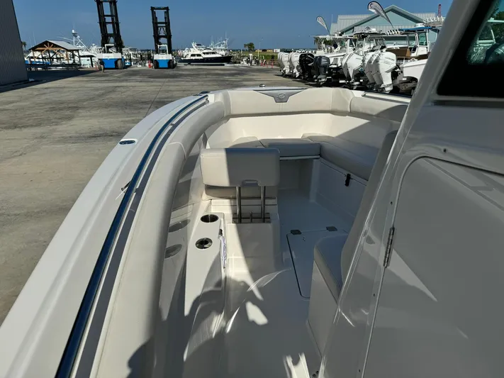  Yacht Photos Pics 2025 Sailfish 272 CC boat interior at marina, showcasing seating and deck layout.