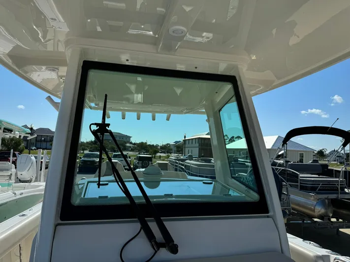  Yacht Photos Pics 2025 Sailfish 272 CC boat windshield with wiper, docked under clear blue sky.