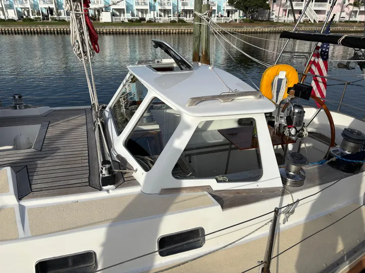 Colleen Yacht Photos Pics 1984 Cambria 44/46 sailboat docked, featuring a sleek cabin and wooden deck.