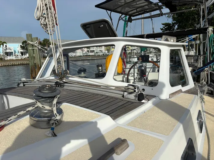 Colleen Yacht Photos Pics 1984 Cambria 44/46 sailboat deck with winch and ropes in a marina setting.