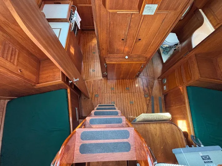 Colleen Yacht Photos Pics Interior of 1984 Cambria 44/46 sailboat with wooden finish and compact layout.