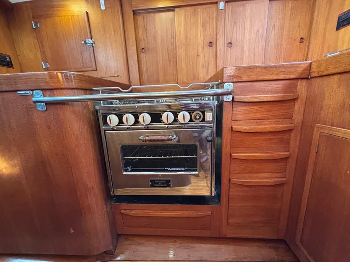Colleen Yacht Photos Pics 1984 Cambria 44/46 yacht kitchen with wooden cabinetry and stainless steel oven.