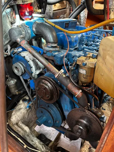 Colleen Yacht Photos Pics 1984 Cambria 44/46 engine, blue components, visible belts and hoses, in a boat engine room.