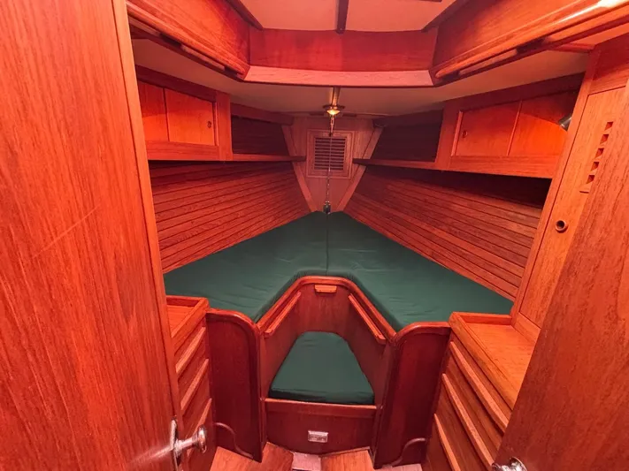 Colleen Yacht Photos Pics 1984 Cambria 44/46 yacht interior with wooden finish and green bedding.