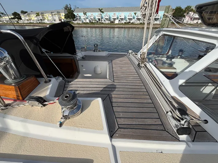 Colleen Yacht Photos Pics Deck of 1984 Cambria 44/46 sailboat with winches, docked near colorful waterfront buildings.