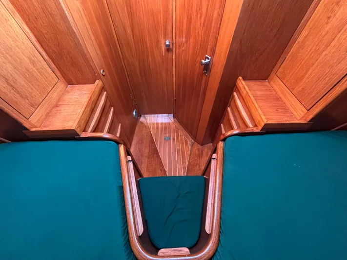 Colleen Yacht Photos Pics Wooden interior of 1984 Cambria 44/46 yacht with green cushions and elegant design.
