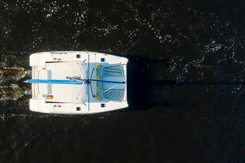  Yacht Photos Pics Aerial view of 2025 Smart Cat S280 catamaran sailing on dark water.