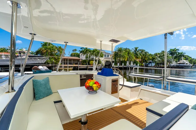  Yacht Photos Pics Luxurious 2025 Smart Cat S280 yacht interior with seating, table, and waterfront view.