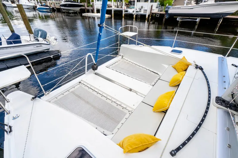  Yacht Photos Pics Modern Smart Cat S280 yacht deck with yellow cushions, docked by the water.