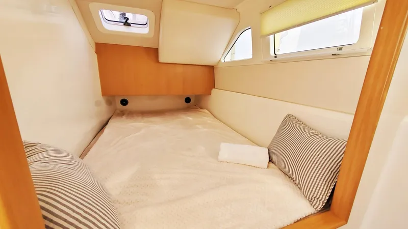  Yacht Photos Pics Cozy cabin interior of 2025 Smart Cat S280 with striped pillows and natural light.