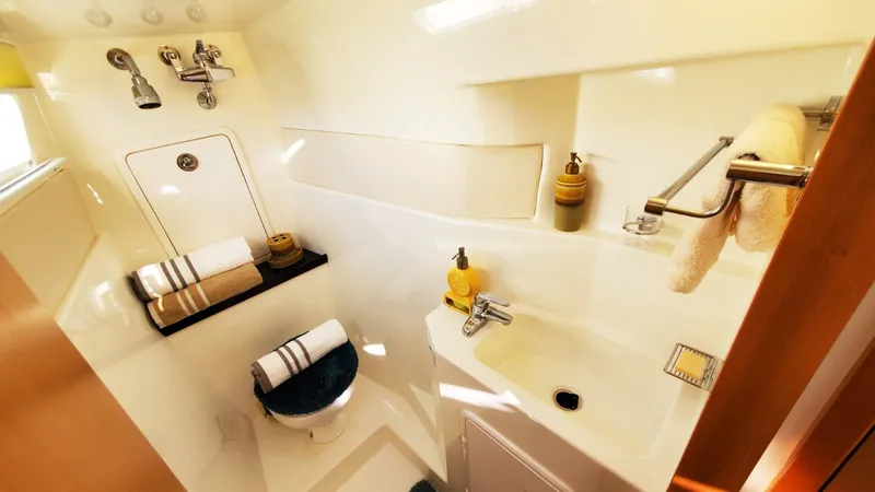  Yacht Photos Pics Compact bathroom in 2025 Smart Cat S280, featuring modern fixtures and neatly arranged towels.