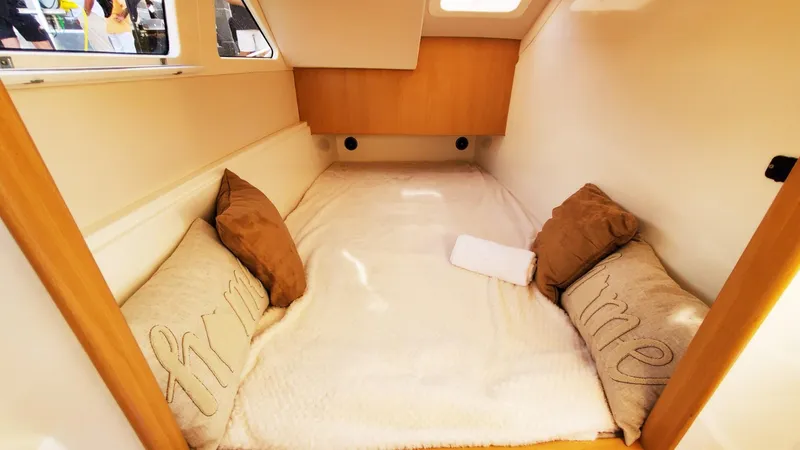  Yacht Photos Pics Cozy cabin interior of 2025 Smart Cat S280 with plush bedding and pillows.