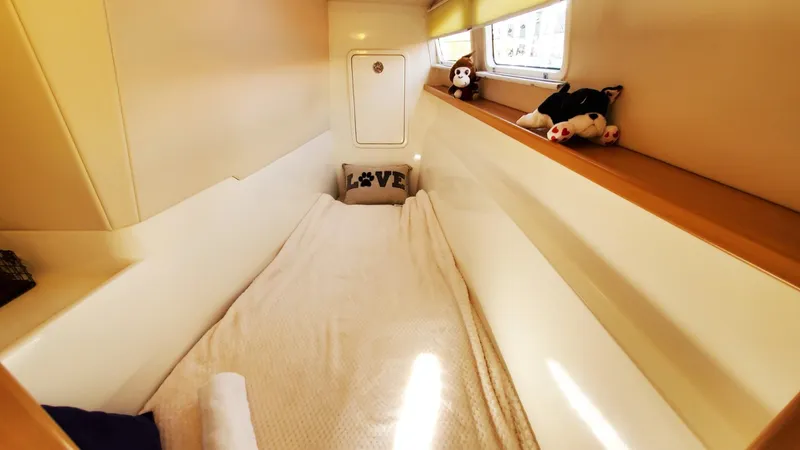  Yacht Photos Pics Cozy cabin interior of 2025 Smart Cat S280 with plush toys and "Love" pillow.