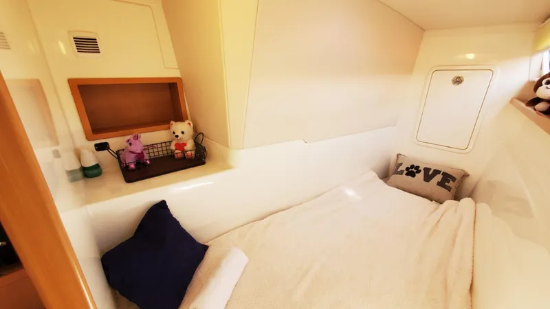  Yacht Photos Pics Cozy cabin interior of 2025 Smart Cat S280 with plush toys and decorative pillows.