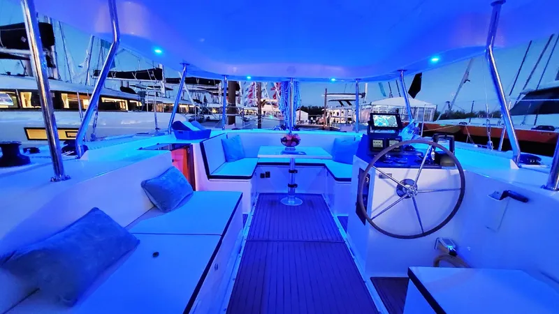  Yacht Photos Pics Luxurious 2025 Smart Cat S280 yacht interior with blue LED lighting at a marina.
