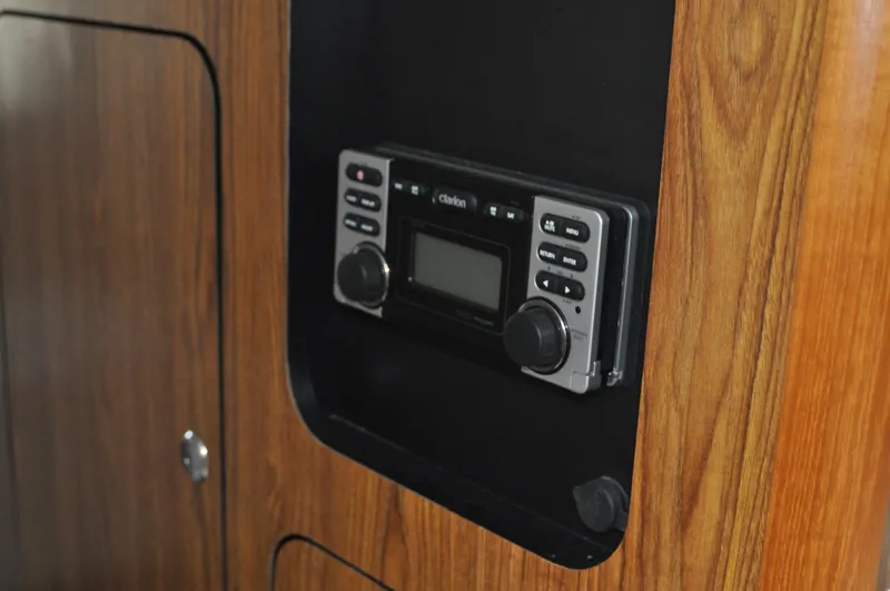  Yacht Photos Pics Built-in stereo system on 2014 Pursuit OS 315 Offshore boat with wood paneling.