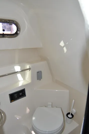  Yacht Photos Pics 2014 Pursuit OS 315 Offshore boat bathroom interior with porthole and toilet.