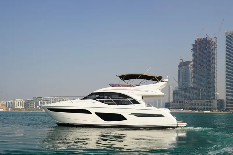 Princess F50 Model 2022 Yacht Photos Pics 2022 Princess F50 yacht cruising near modern city skyline.