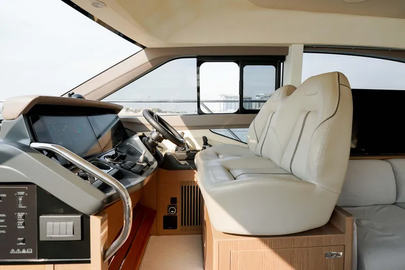 Princess F50 Model 2022 Yacht Photos Pics Luxurious interior of 2022 Princess F50 yacht with modern helm and plush seating.