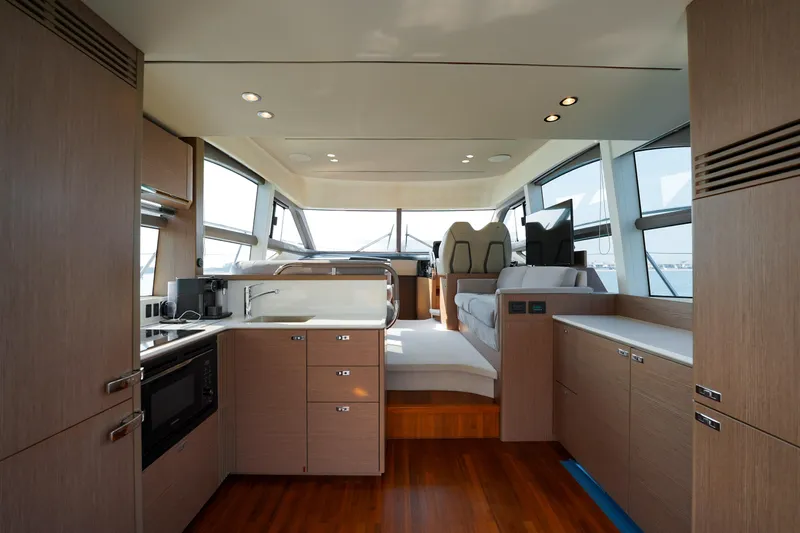 Princess F50 Model 2022 Yacht Photos Pics Luxurious interior of 2022 Princess F50 yacht with modern kitchen and seating area.