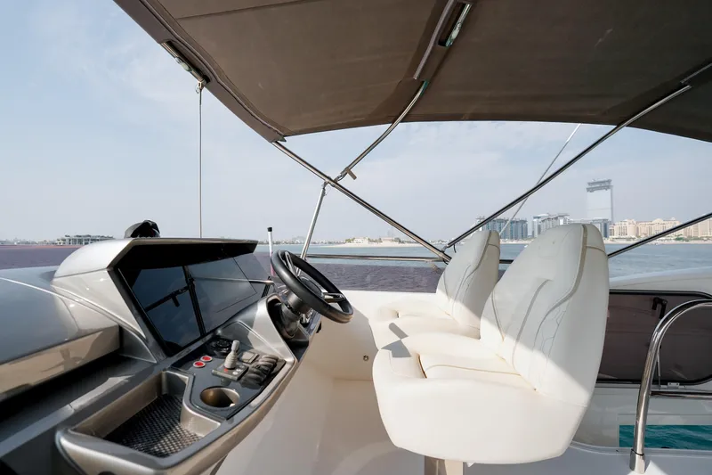 Princess F50 Model 2022 Yacht Photos Pics Luxurious 2022 Princess F50 yacht cockpit with modern controls and white leather seats.