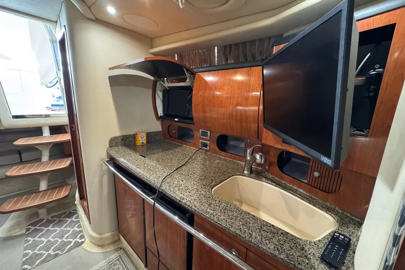 The Judy Len Yacht Photos Pics Interior of 2005 Sea Ray 360 Sundancer yacht with kitchenette and TV.