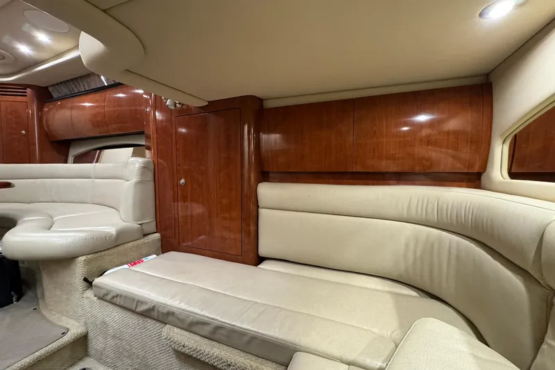 The Judy Len Yacht Photos Pics Luxurious interior of 2005 Sea Ray 360 Sundancer with plush seating and wooden cabinetry.