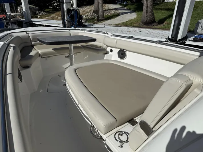  Yacht Photos Pics 2020 Boston Whaler 330 Outrage boat interior with seating and table.
