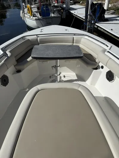  Yacht Photos Pics 2020 Boston Whaler 330 Outrage boat interior with seating and table.