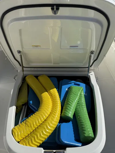  Yacht Photos Pics Open storage compartment on 2020 Boston Whaler 330 Outrage, filled with colorful flotation devices.