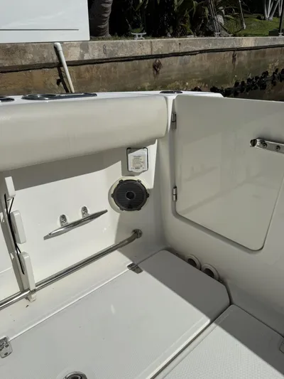  Yacht Photos Pics 2020 Boston Whaler 330 Outrage boat interior with seating and storage compartment.
