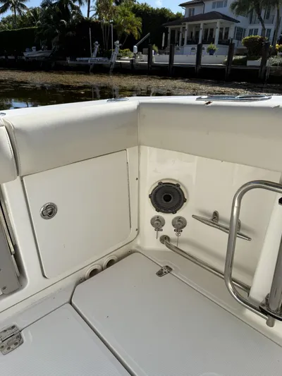  Yacht Photos Pics Boston Whaler 330 Outrage 2020 boat interior with seating and speaker, dockside view.