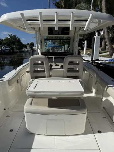  Yacht Photos Pics 2020 Boston Whaler 330 Outrage boat interior with seating and helm station.