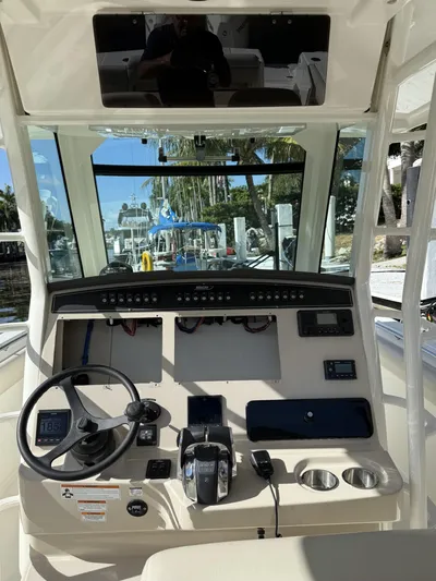  Yacht Photos Pics 2020 Boston Whaler 330 Outrage helm with steering wheel and control panel.